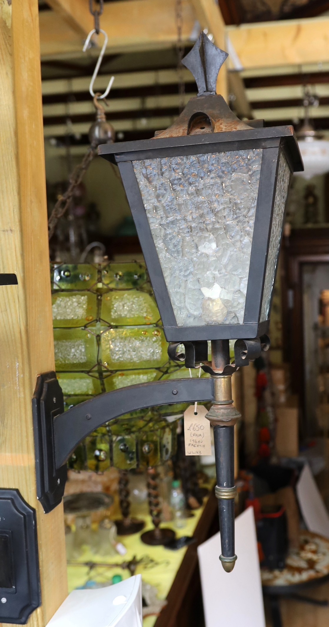 A pair of 1960s French brass mounted wrought iron carriage lanterns, height 64cm. depth 34cm